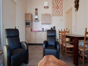 a living room with a table and chairs and a kitchen at Quaint Farmhouse in Geesteren with Meadow View in Geesteren