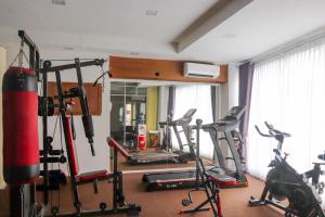 a gym with several exercise bikes in a room at Abadi Hotel Malioboro Yogyakarta by Tritama Hospitality in Yogyakarta