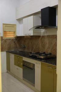 a kitchen with a stove and a counter top at Authentique Home Abode - 3 Bedroom & Living in Udaipur