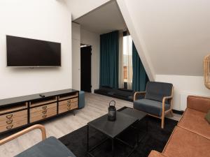 A television and/or entertainment centre at Luxury apartment in Renesse with infrared sauna