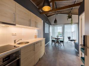 eine Küche mit einem Tisch und einem Esszimmer in der Unterkunft Lovely modern 4 person apartment in the heart of Koudekerke in Koudekerke