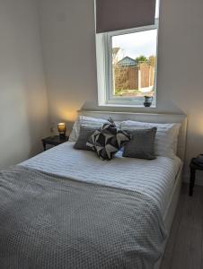 a bedroom with a bed with pillows and a window at The boot factory in Leicester