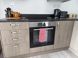a kitchen with an oven with a red and white towel at The boot factory in Leicester