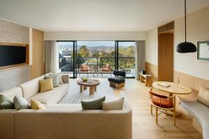 a living room with a couch and a table at Six Senses Kyoto in Kyoto