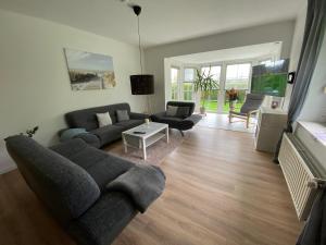 a living room with a couch and a table at Ferienwohnung Sommer in Bramstedt