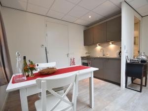 a kitchen with a white table and white chairs at Alluring Apartment in Bergen with Terrace Garden and BBQ in Bergen