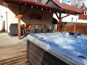 a hot tub on the deck of a house at Ubytování BRLOH Sedloňov v Orlických horách in Sedloňov
