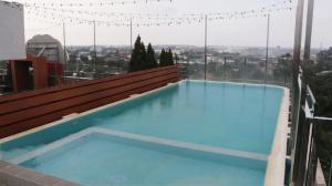 a large swimming pool on top of a building at Pakons Prime Hotel in Tangerang
