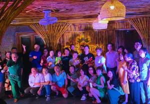 a group of people posing for a picture in a room at TIEN TAI HOTEL 1 in Mèo Vạc