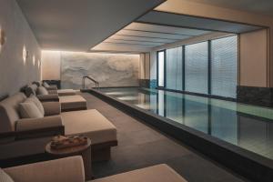 a living room with a swimming pool and a house at Six Senses Kyoto in Kyoto