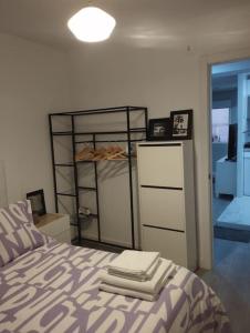 a bedroom with a bed with three towels on it at Apartamento acogedor. in Gelves
