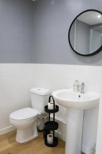 a bathroom with a white toilet and a sink at The Live and Let Live in Downham Market +4 photos