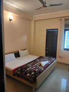 a bedroom with a large bed in a room at The Anand with Ganga View and Rooftop Cafe in Rishīkesh