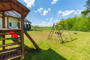a playground with a swing set in a yard at Peaceful house with sauna in Nowe Czaple