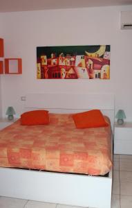 a bed with two red pillows in a bedroom at Azzurra in Marciana Marina