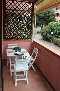 a white table and chairs sitting on a porch at Azzurra in Marciana Marina