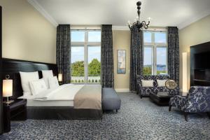 a bedroom with a bed and a large window at Hotel Atlantic Hamburg, Autograph Collection in Hamburg