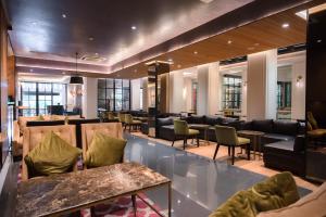 a hotel lobby with couches and tables and chairs at The Mirah Bogor in Bogor