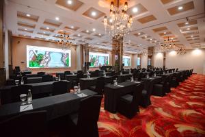 a large room with black tables and chairs at The Mirah Bogor in Bogor