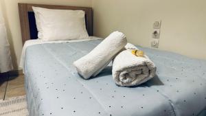 a bed with a stuffed animal on top of it at Patras Centre Apartment in Patra