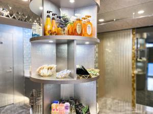 a shelf filled with lots of bottles of orange juice at HOTEL PARK SIDE in Tokyo