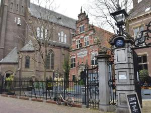 a bike parked in front of a gate in front of a building at Spacious holiday home in Enkhuizen with terrace in Enkhuizen