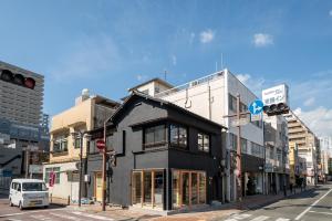 a building on the corner of a city street at Ebisuya / Vacation STAY 5851 in Kofu