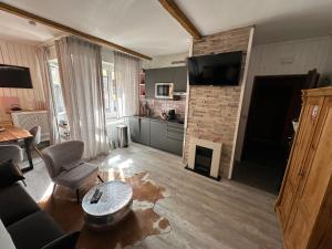 a living room with a couch and a fireplace at Appartamento Kern-Sciare A Portata Di Mano- in Madesimo