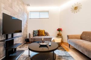 a living room with a couch and a tv at Fully furnished house for families with infants. in Osaka