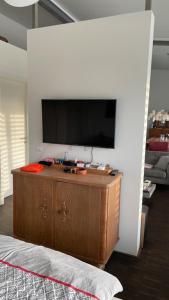 a living room with a flat screen tv on a wall at Ferienhaus Rolf in Peterswald-Löffelscheid