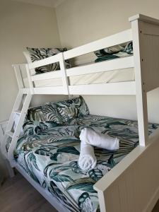 a bunk bed with a towel on the bottom bunk at Terrigal Beach House in Terrigal