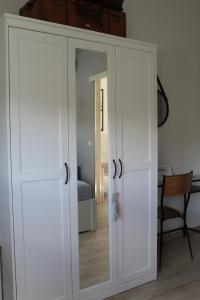 a white cabinet with a mirror in a room at Da la Nada in Goro