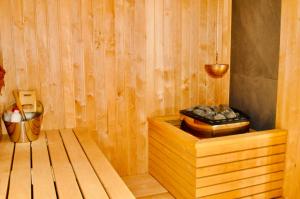a wooden sauna with a box of rocks in it at LOG OUT in Zăbala