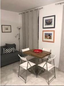 a living room with a wooden table and chairs at La Sardina 2.0 in Riomaggiore