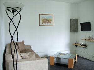 a living room with a couch and a table at Sweethome-Epinal in Épinal