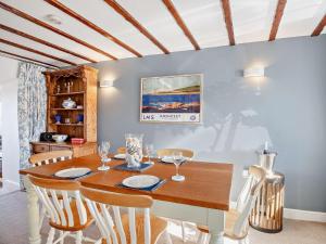 a dining room with a wooden table and chairs at 3 Bed in Cemaes 92812 in Llanfechell