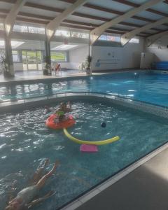 a child in an inner tube in a swimming pool at Kingsdown Chalet in Deal