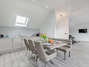 a kitchen and dining room with a table and chairs at 4 Bed in Branston 94516 in Branston