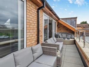 a patio with a couch and chairs on a balcony at 4 Bed in Branston 94516 in Branston