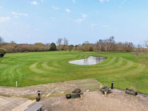 an aerial view of a golf course with a pond at 4 Bed in Branston 94516 in Branston