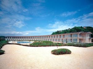 a large building with a beach in front of it at Kamakura Prince Hotel in Kamakura
