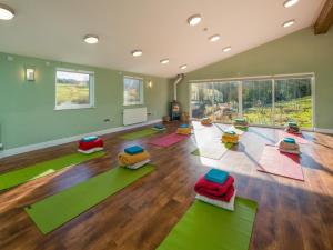 a yoga room with colorful mats on the floor at 5 Bed in Godshill 94494 in Godshill