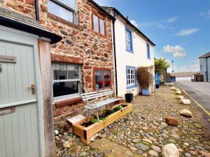 a stone house with a garden in front of it at 1 Bed in Ravenglass 94503 in Ravenglass