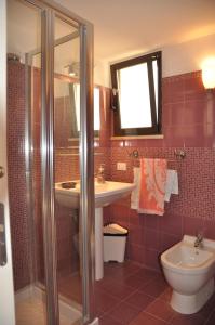 a bathroom with a sink and a toilet at Donna Lucia in Giardini Naxos