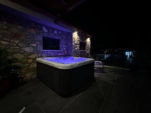 a jacuzzi tub in a stone building at night at Amfikleias Earth houses in Amfiklia