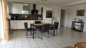 a kitchen with a table and chairs in it at Ferienwohnung am Wald in Warstein