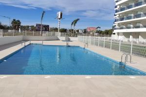 a large blue swimming pool next to a building at Apartamento Domara Vera in Vera