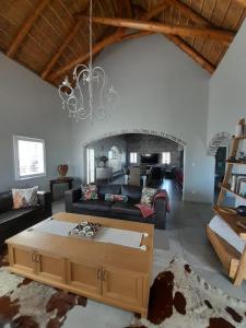 a living room with a couch and a coffee table at Zeezicht Villa - Jacobsbaai in Jacobs Bay