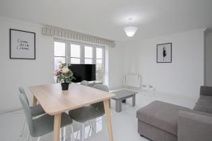 a living room with a table and a couch at Riverview Apartment in Glasgow