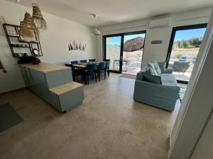 a living room with a couch and a table and chairs at Lemon Navy house in Vodice